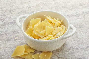 Sliced parmesan cheese heap in the bowl