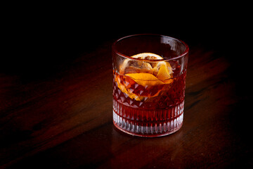 negroni with campari vermouth and gin and dried oranges at an angle