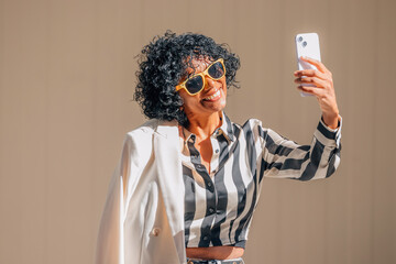 middle aged woman with mobile phone in summer on the street