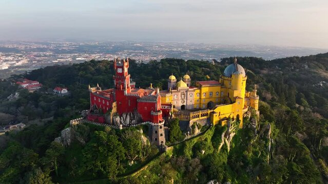 Drone flight around Pena Castle in sunset light. Sintra sunset