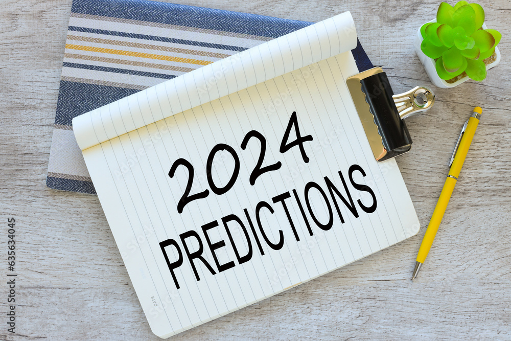 Poster 2024 predictions wooden table.yellow notepad and open notebook with text