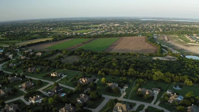 Aerial view of Parker Texas neighborhood next to large undeveloped farm field