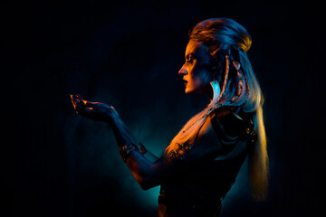 Photo of wild mysterious lady wear viking clothes praying demons isolated dark orange blue color background