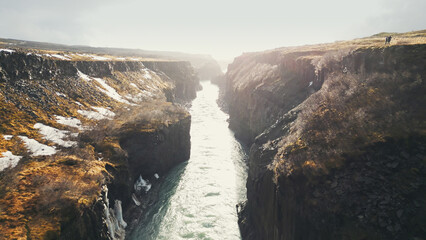 Drone shot of gullfoss waterfall in iceland, majestic cascade flowing between nordic canyon hills....