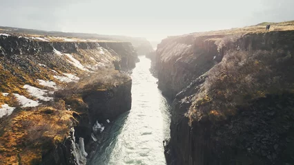  Drone shot of gullfoss waterfall in iceland, majestic cascade flowing between nordic canyon hills. Icelandic water stream falling down from cliffs. Slow motion. © DC Studio
