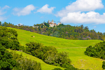 Hearst Castle on top of the mountain. Hearst Castle is a National Historic Landmark and California Historical Landmark. Panoramic bottom up view of Hearst Castle. Landmarks of California in America