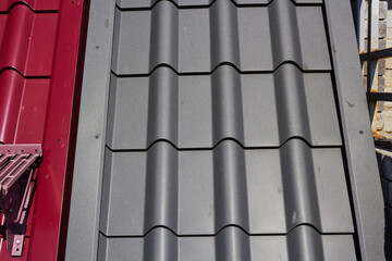 gray and red metal tile. Roof covering. Construction