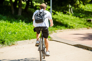 Naklejka premium Cyclist ride on the bike path in the city Park 