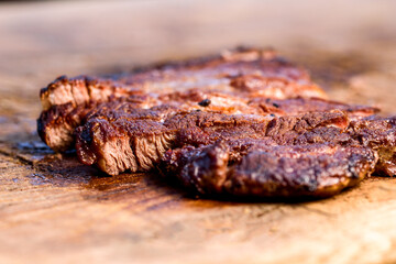 Fresh roast beef meat steak on cutting board. Fresh roast ribeye steak slices.