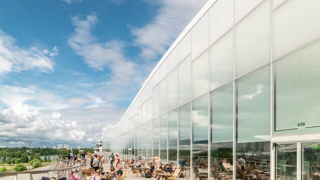 Time lapse of  white clouds move over the Helsinki Central Library Oodi building