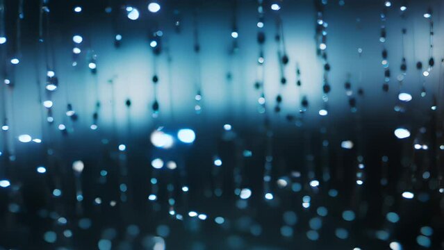 Rain drops of varying sizes rapidly moving across the sky in random patterns and directions occasionally Abstract wallpaper background