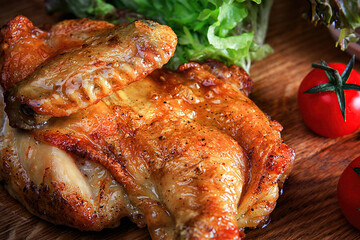 Fried chicken on a wooden board. Close up