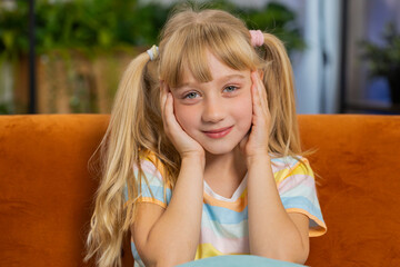 Close-up portrait of happy smiling Caucasian preteen school girl 7 years old. Young blonde lovely...