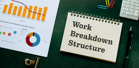 There is notebook with the word Work Breakdown Structure. It is as an eye-catching image.