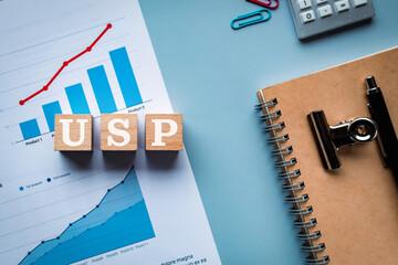 There is wood cube with the word USP. It is an abbreviation for Unique Selling Proposition as eye-catching image.