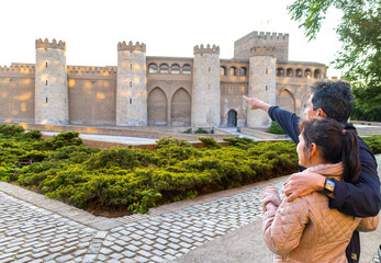Latin adult couple visiting the Aljaferia Palace in Zaragoza, Spain.
