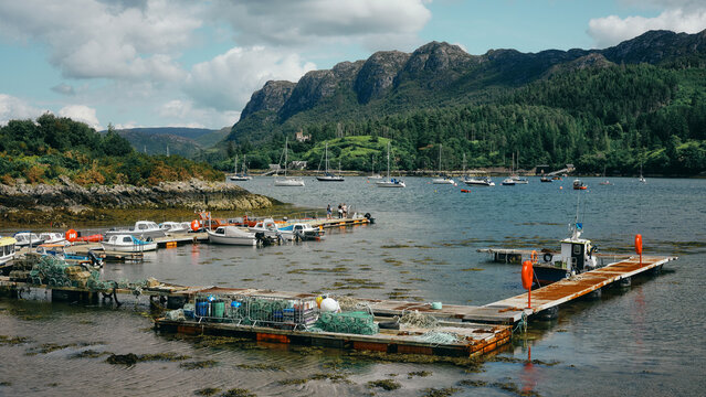 boats in bay with mountains in the distance