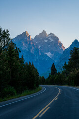 Naklejka premium Road Curves Left With Grand Teton In The Distance