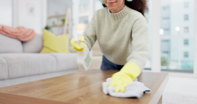 Headphone, music and woman spring cleaning on a table in home living room as for hygiene, protection or disinfection. Dirt, dust and person or cleaner doing domestic or sanitary housekeeping work