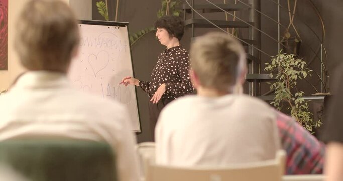 concepts lecturer will explain complex psychological terms and concepts, making them more understandable audience symbol heart drawn teacher makes mark hand. Backs listeners bokeh.