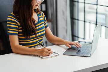 Excited Asian female student doing Online MBA and Business Degree Programs and learn indian language, online MBA course give you same level education provided conventional business school