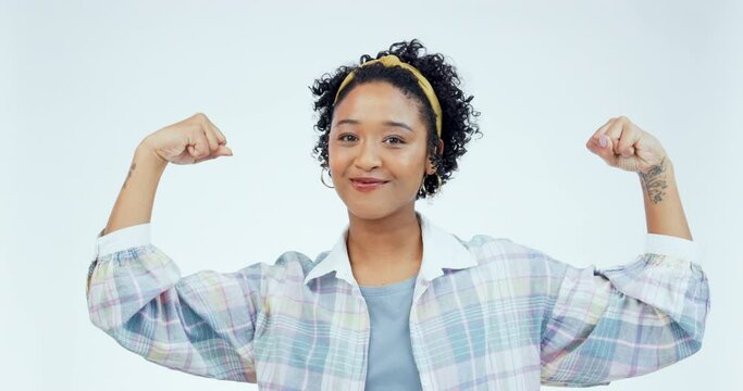 Arm, flex and woman face in studio happy, confident and empowered with success emoji on white background. Strong, flexing and portrait of female winner with positive attitude, mindset and champion