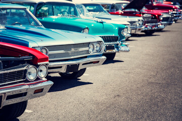 Vintage cars in a row at a car show on the street