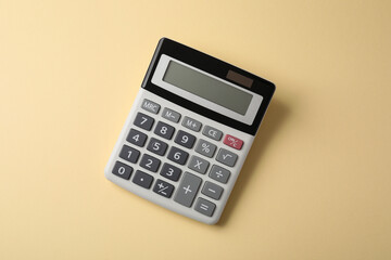 Calculator on beige background, top view. Office equipment