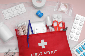 Flat lay composition with first aid kit on pink background