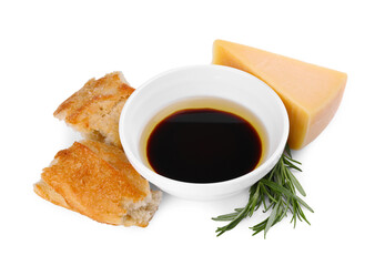 Bowl of balsamic vinegar with oil, bread, parmesan cheese and rosemary on white background