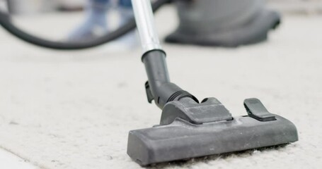 Vacuum, carpet and cleaning in living room, dust and dirt removal in domestic service at home. Person, maid or housekeeper with suction machine on interior, floor rug or mat for germ or bacteria