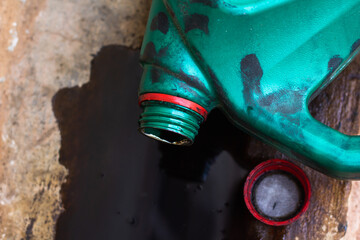 old motor oil bottlem, Black old oil lubricant, used car engine spilled on concrete floor.