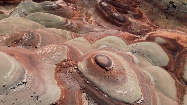 Aerial-Top down-Pulling back over view of Bentonite Hills with brilliant colored bands of bentonite clay in scalloped patterns, a beautiful display of nature's handiwork.