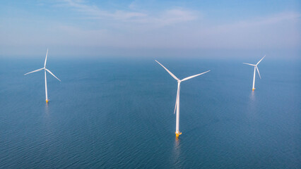 Wind mill turbines park with clouds and a blue sky, windmill park in the ocean aerial view with wind turbine Flevoland Netherlands Ijsselmeer. Green Energy production in the Netherlands