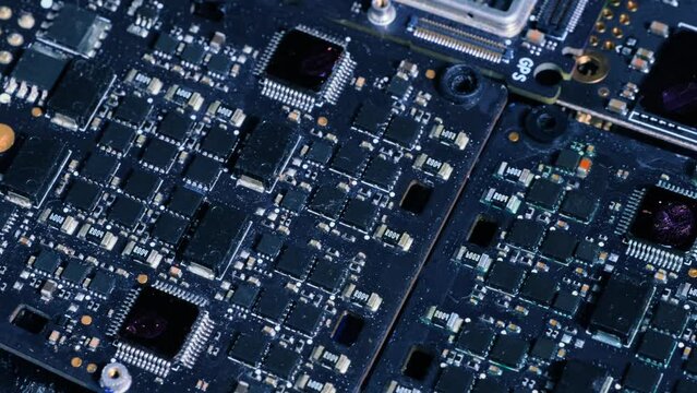 Microcircuit, motherboard from laptop slow tracking shot, computer components macro close up. PC chip, cpu, circuits.