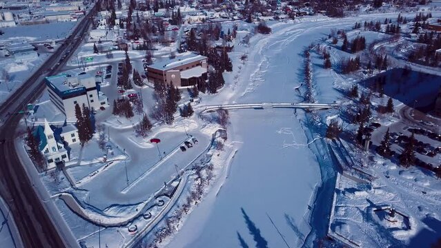 4K Drone Video of The William Ransom Wood Centennial Bridge over Frozen Chena River in Downtown Fairbanks Alaska on Snowy Winter Day