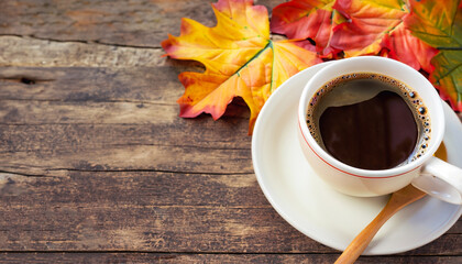 Cup of coffee on old wood in autumn season with maple leaves of colorful and copy space. Seasonal...