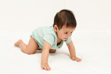 Fototapeta premium happy infant crawling on floor inside baby playpen