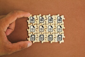 wooden puzzle with stacked file icons. Concept document management system or DMS. Concept Concept...