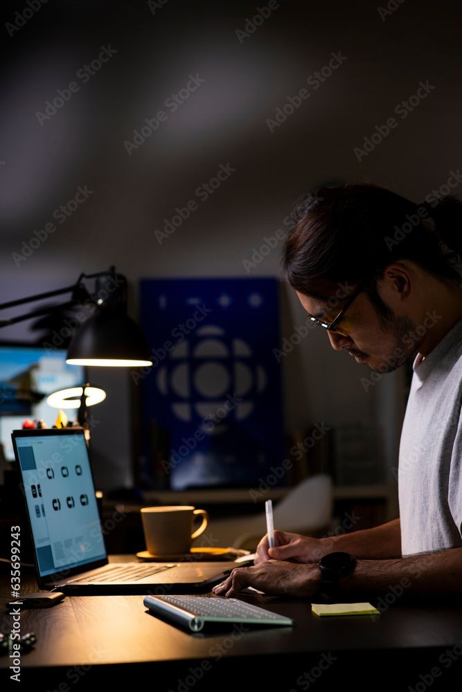 Fototapete asian man graphic designer working on computer drawing sketches logo design. the concept of a new br