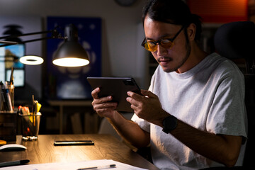 Asian man graphic designer working on computer drawing sketches logo design. The concept of a new...