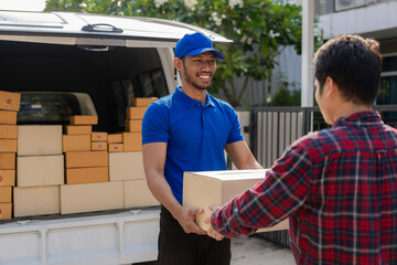 Smiling african american courier holding cardboard box delivering parcel to business customer signing electronic signature POD device on smartphone