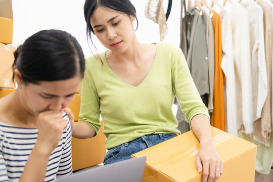 Woman Seller SME Retail Store Owner Work Hard Worry Stress In Bad News On Laptop At Home Office. Asian People Crisis Online Selling Job Issue Feel Tired Tough And Upset In Cash Money Loss Or Loan Debt