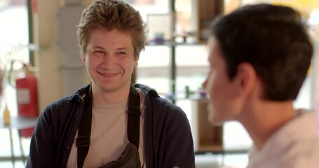 Portrait of a young man during a conversation. Involuntary laughter or smiling as psychological defense mechanism. Coping mechanism helps individuals navigate uncomfortable or distressing topics.