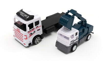 Toy truck with trailer and excavator on white background.
