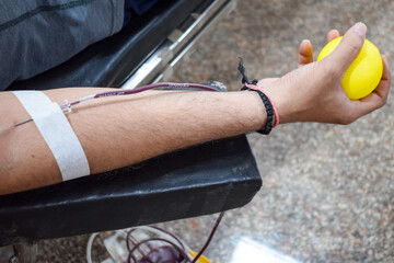 Blood donor at Blood donation camp held with a bouncy ball holding in hand at Balaji Temple, Vivek...