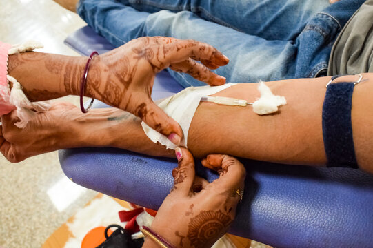Blood donor at Blood donation camp held with a bouncy ball holding in hand at Balaji Temple, Vivek Vihar, Delhi, India, Image for World blood donor day on June 14 every year, Blood Donation Camp