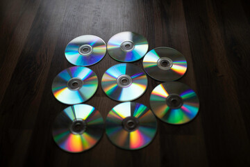 cd plates splitting light, diffraction. group of plates on the floor.