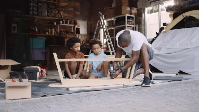 Black Man Builds Table with Sons