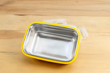 New empty stillness steel lunch box on a wooden background